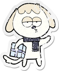 distressed sticker of a cartoon bored dog with christmas present