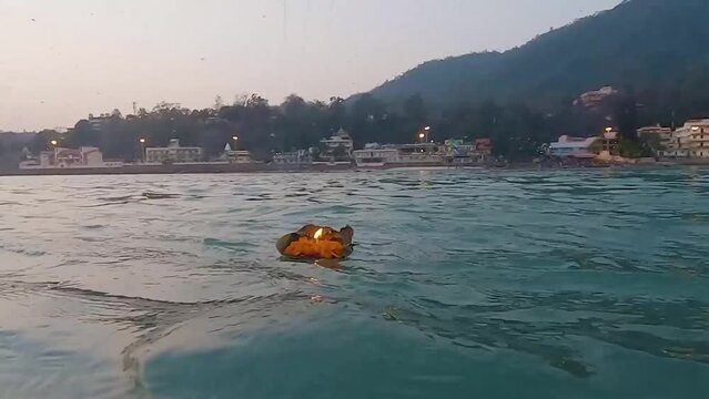 worship offerings to holy river ganges at morning from flat angle video is taken haridwar uttrakhand india on Mar 15 2022.