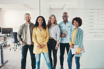 Diverse team of smiling businesspeople standing together in an office