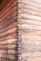 the corner of a wooden house with dovetail joints