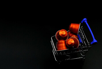 A shopping cart or supermarket trolley with coffee capsules