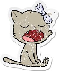 distressed sticker of a cartoon yawning cat
