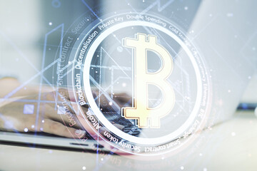 Creative Bitcoin concept with hands typing on computer keyboard on background. Double exposure