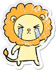 distressed sticker of a cartoon crying lion