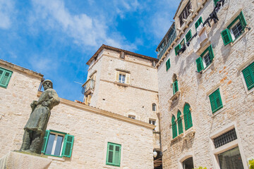 Statue and old houses in the town of Sibenik, Croatia