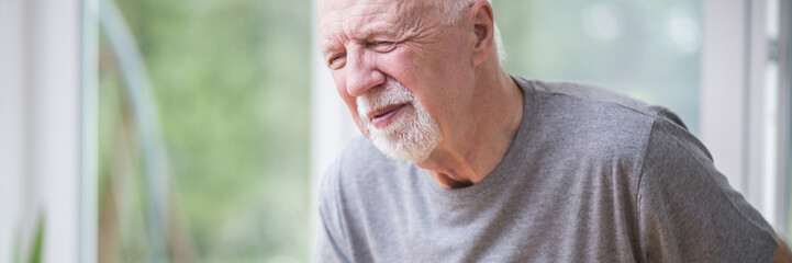 Senior grey man home alone having a heart attack