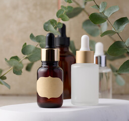 Two glass bottles with pipettes, packaging for cosmetics, advertising and promotion