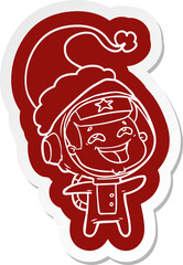 quirky cartoon  sticker of a laughing astronaut wearing santa hat