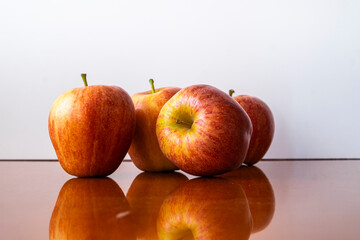 Four fresh red apples on a white background.