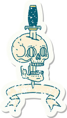 worn old sticker with banner of a skull