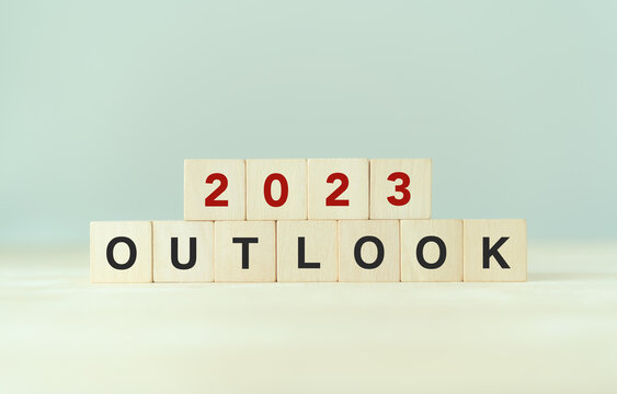 Economic Outlook Concept. Financial, Business Review Or Economic Growth Forecast For 2023. OUTLOOK 2023 Text On Wooden Cube Blocks.