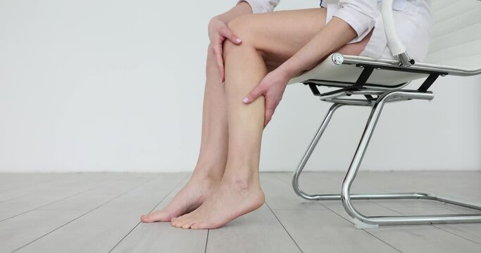 Woman takes care of calf and does massage. Pain in calves of legs