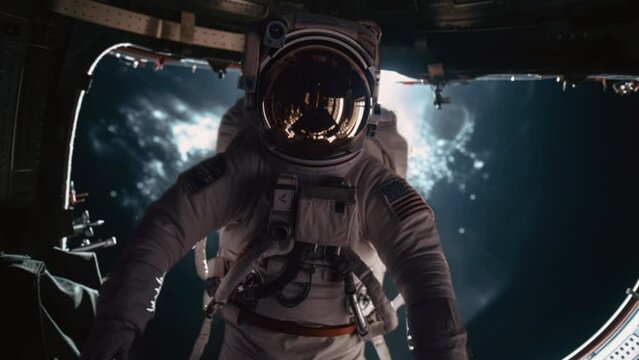 An American Astronaut in a space suit floating into a spaceship air lock dock on a space station spacecraft