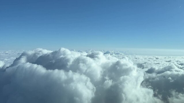A pilot&rsquo;s perspective of a stormy spring sky full of clouds whe overflying some cumulus.