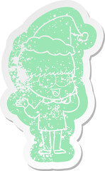 happy quirky cartoon distressed sticker of a boy wearing santa hat