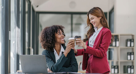 Two business people talk project strategy at office meeting room. Businessman discuss project planning with colleague at modern workplace while having conversation and advice on financial data report.