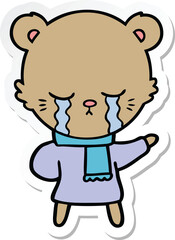 Obraz premium sticker of a crying cartoon bear wearing winter clothes