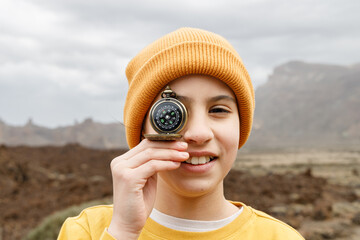 Portrait of a girl explorer with a compass on her face, concept of adventurous traveler