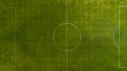 Aerial view of green football, soccer pitch. Top down view on a green, empty soccer field