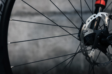 Hydraulic bicycle disk brakes, grey metal disc attached to bike wheel close up, effective popular...