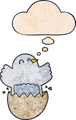 cartoon hatching chicken with thought bubble in grunge texture style