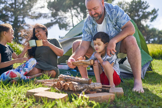 Father and son with Down Syndrome stacking firewood at campsite