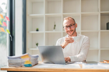 Serious Businessman Working At Laptop Computer Typing Something In Office. Business Career Concept. Copy Space