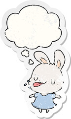 cartoon rabbit with thought bubble as a distressed worn sticker