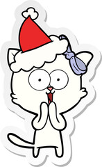 hand drawn sticker cartoon of a cat wearing santa hat