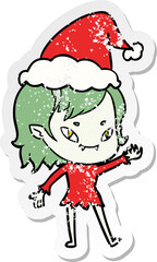 hand drawn distressed sticker cartoon of a friendly vampire girl wearing santa hat