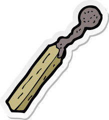 sticker of a cartoon burnt match