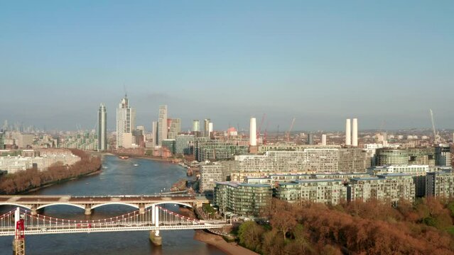 Rising aerial shot over Battersea Power station by the river thames