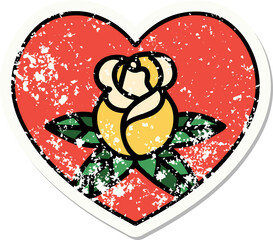 distressed sticker tattoo in traditional style of a heart and flowers