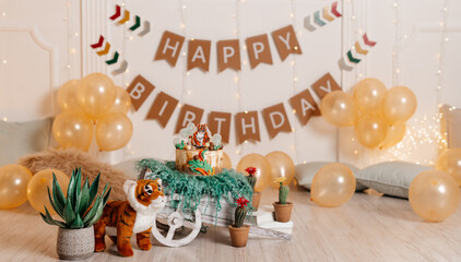 chic photo session in a photo studio for a one-year-old boy in the style of the jungle, safari