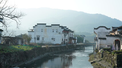 
One old traditional Chinese village view with the old arched stone bridge and old wooden buildings in the Southern countryside of the China