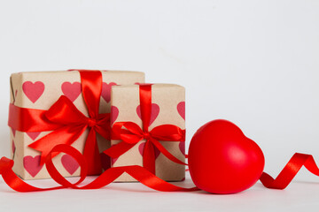 gift box with red bow and red heart on colored background. Perspective view. Flat lay