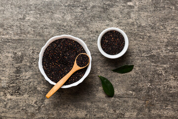 quinoa seeds in bowl and spoon on colored background. Healthy kinwa in small bowl. Healthy superfood