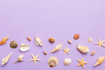Summer time concept Flat lay composition with beautiful starfish and sea shells on colored table, top view with copy space for text