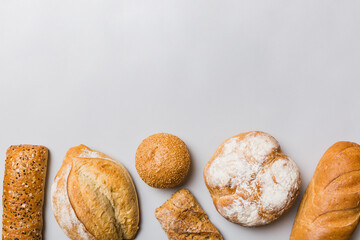 Homemade natural breads. Different kinds of fresh bread as background, top view with copy space
