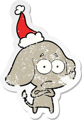 hand drawn distressed sticker cartoon of a unsure elephant wearing santa hat
