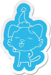 quirky cartoon  sticker of a dog sticking out tongue wearing santa hat