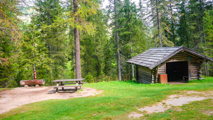 Colfosco, Corvara, South Tyrol, Italy. View of a free mountain hut in alpine pine and spruce forests