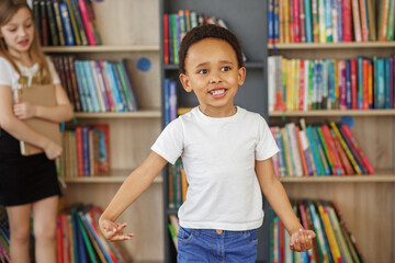 Mixed race schoolboy having fun and running indoors at school. Back to school.