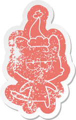 bored quirky cartoon distressed sticker of a cat wearing santa hat