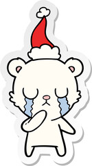 crying polar bear hand drawn sticker cartoon of a wearing santa hat