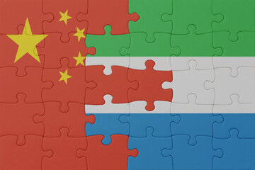 puzzle with the national flag of sierra leone and china . macro.concept.