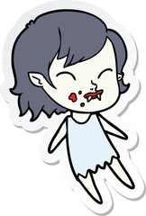 sticker of a cartoon vampire girl with blood on cheek