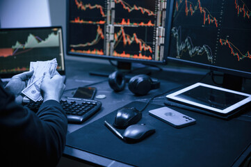 Financial Analyst Working on a Computer with Multi-Monitor Workstation with Real-Time Stocks, Commodities and Exchange Market Charts.