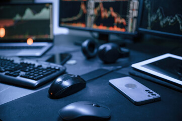 Financial Analyst Working on a Computer with Multi-Monitor Workstation with Real-Time Stocks, Commodities and Exchange Market Charts.