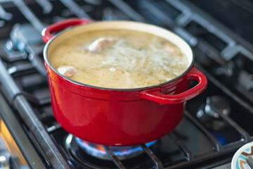 White zurek with kielbasa on the stove cooking 